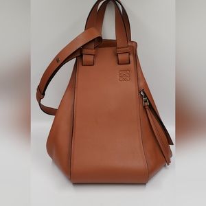 Loewe hammock bag medium classic calfskin tan bag with bottom feet and pouch.
